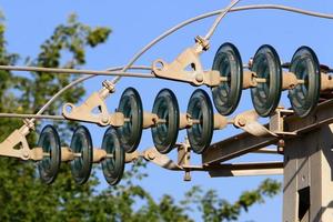 Wires on a pole carrying high voltage electric current. photo