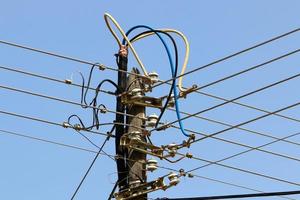 Wires on a pole carrying high voltage electric current. photo