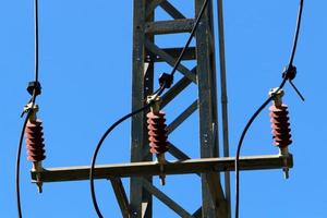 Wires on a pole carrying high voltage electric current. photo