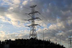 Wires on a pole carrying high voltage electric current. photo