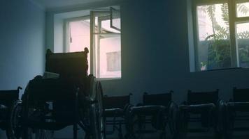 Side view of one American male workers in a workshop at a factory making wheelchairs, sitting at a workbench using hand tools and assembling parts of a product, sitting in wheelchairs video