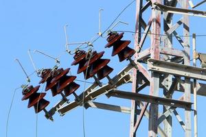 Wires on a pole carrying high voltage electric current. photo