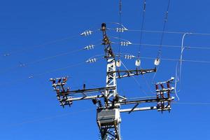 Wires on a pole carrying high voltage electric current. photo