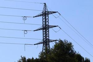 Wires on a pole carrying high voltage electric current. photo