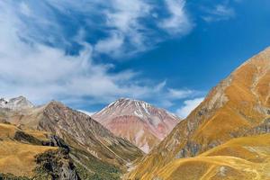 Early autumn in the mountains, view of the Caucasus mountains from the valley of the devil. Banner with space for text, trip to Georgia, trekking in the mountains photo