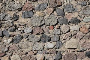 Old stone wall made of raw stones, background and screensaver idea photo