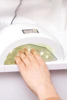 Process for drying of nails with UV lamp machine photo