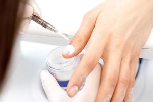 Process of applying acrylic powder on the nails photo