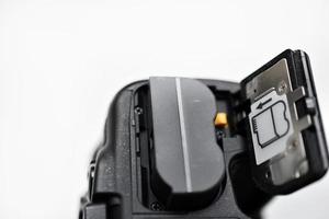 The battery of the SLR camera. Changing the camera battery in close-up. The camera battery is in the photographer's hand. photo