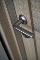 The door handle at the front door. Beautiful iron handle on a yellow wooden door. photo