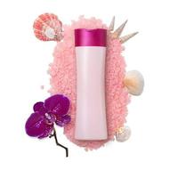 Pink bottle mockup on sea salt with seashells, molluscs and orchid on white isolated background. Copy space photo