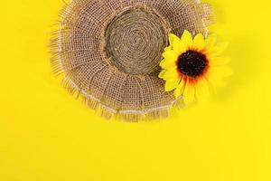 Straw hat. Summer headwear from burlap and jute with a hearing on yellow background. Copy space photo