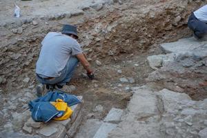 Bergamo Italy September  2022 Archaeologist at work in ancient Roman road in upper city in Bergamo photo