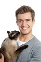 young man with siamese cat photo