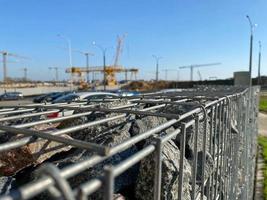Iron metal mesh reinforcement on a concrete wall in the construction of houses by industrial methods with the help of cranes photo