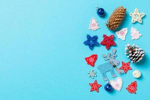 Top view of New Year toys and decorations on blue background. Christmas time concept with empty space for your design photo