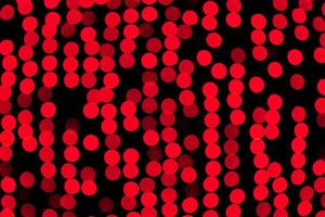 Unfocused abstract red bokeh on black background. defocused and blurred many round light photo