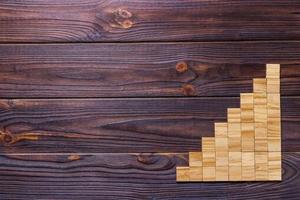 A wooden blocks cube over black wooden textured background with copy space for add word text title. Concept or conceptual Wood block stair or eight steps. Cubic photo