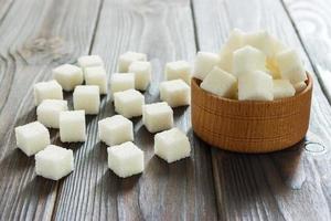 White sugar in bowls on wooden background. Selective focus, horizontal photo