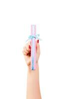 Woman hands give wrapped Christmas or other holiday handmade present in pink paper with blue ribbon. Isolated on white background, top view. thanksgiving Gift box concept photo