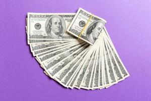 A Hundred dollar currency fan close up, Top view of business concept on colored background with copy space photo