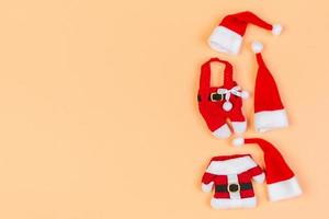 Top view of colorful holiday background made of Santa hats and clothes. Merry Christmas concept with copy space photo