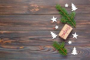 Christmas gift box wrapped in recycled paper, with ribbon top view with copy space on rustic background. Holiday concept photo