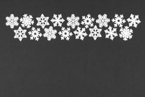 Top view of winter ornament made of white snowflakes on colorful background. Happy New Year concept with copy space photo