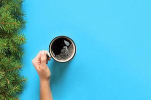 Minimalistic style woman hand holding a mug of coffee on purple background. Flat lay banner , top view photo