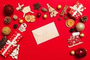 Top view of envelope on red background. New Year decorations. Christmas holiday concept photo