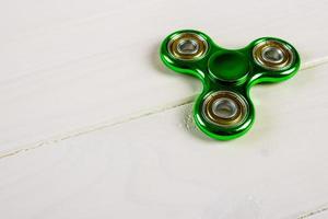 Spinner fidget toy for stress relieving on wood table background with copy space for your creative design project photo