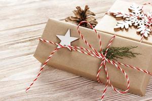 Christmas gift boxes on wooden table with snowflake. Top view with copy space photo