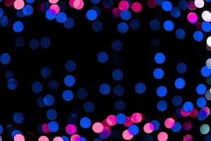 Unfocused abstract colourful bokeh on black background. defocused and blurred many round light photo