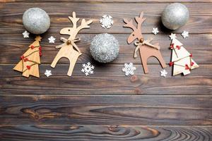 New Year composition made of baubles, reindeer and other decorations on wooden background. Christmas time concept with empty space for your design photo