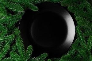 Top view served plate with green fir tree branches. Holiday dinner concept with copy space photo