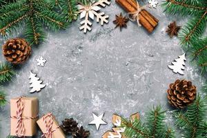 Christmas background with fir tree and gift box on wooden table. Top view vintage, toned with copy space for your design photo