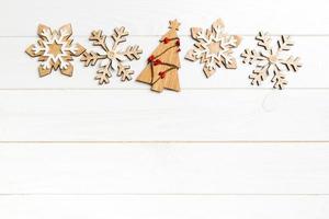 Top view of Christmas decorations and toys on wooden background. New Year holiday concept with empty space for your design photo