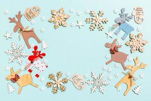 Top view of holiday decorations and toys on blue background. Christmas ornament concept with empty space for your design photo
