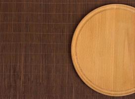 Empty round wooden board with tablecloth. photo