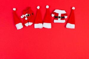 Top view red Santa hats on colorful background. Time for holiday concept with empty space for your design photo