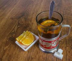 sweet cup of fruit tea with lemon and sugar. photo