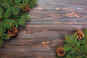 Christmas gray wooden background with fir tree frame and cones copy space. top view empty space for your design photo