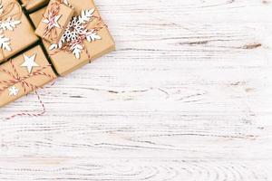 Christmas wooden background with gift boxes and decor. Top view with copy space for your text. Toned photo