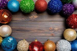 Festive composition of decorative baubles on wooden background. Top view of Christmas toys with copy space photo