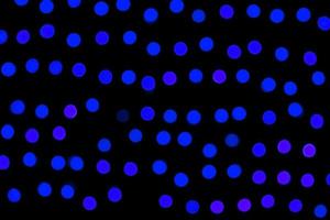 Unfocused abstract dark blue bokeh on black background. defocused and blurred many round light photo