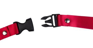 Open black plastic side release buckle with red woven strap attached photo