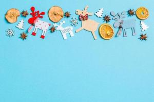 Top view of holiday decorations and toys on blue background. Christmas ornament concept with empty space for your design photo