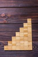 A wooden blocks cube over black wooden textured background with copy space for add word text title. Concept or conceptual Wood block stair or seven steps. Cubic photo