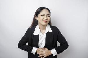 Upset young business woman suffering from stomachache, overworked at office. Gastritis or indigestion or constipation concept photo