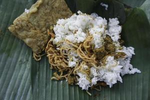 A portrait of Balinese food called Nasi Jinggo on banana leaf photo